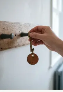 A hand hanging a brass key on a wooden peg, from the Hollow and Hearth example build. The sentence on that site is the example's own, not a customer quote.