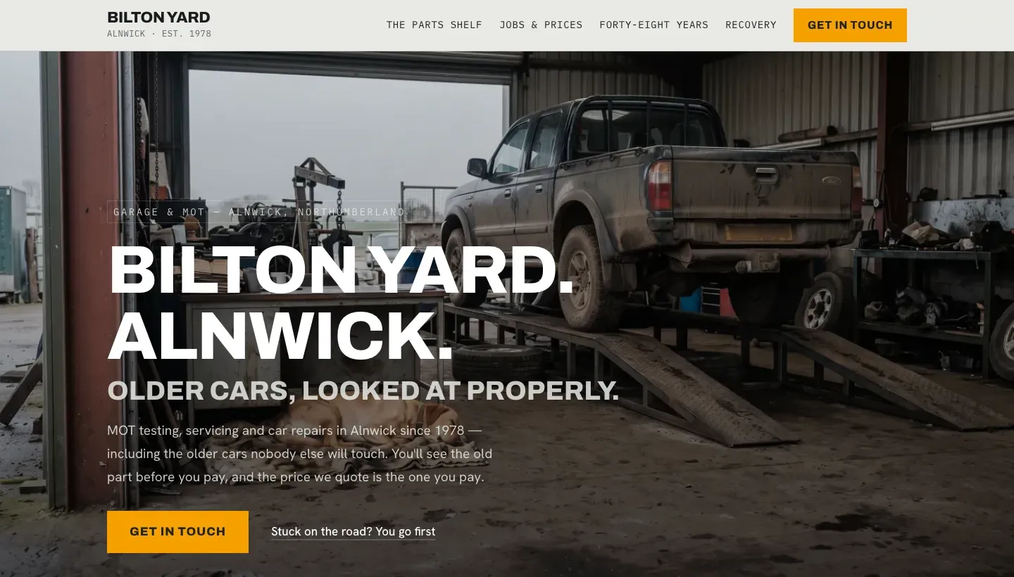 The opening of Bilton Yard, a fictional village garage in Alnwick. The headline is about older cars looked at properly. The review score that appears further down the live example is invented and is not shown here.