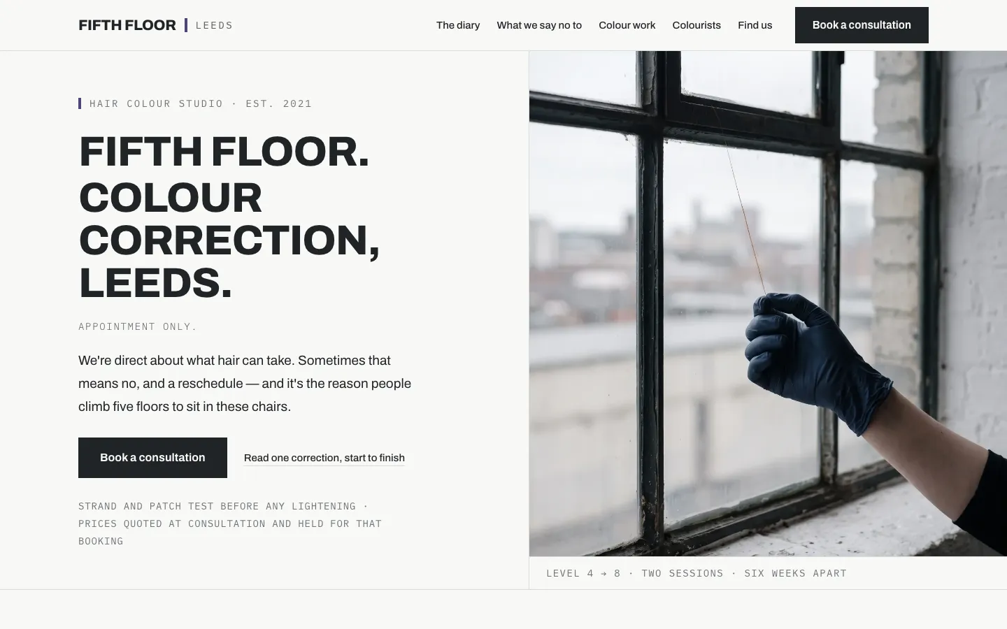 The first screen of Fifth Floor, an example build for a fictional colour studio in Leeds. The headline reads Fifth Floor, colour correction, Leeds, appointment only. A book button sits under a line about a strand and patch test before lightening. A window photograph shows a gloved hand holding a strand, captioned level 4 to 8, two sessions, six weeks apart.